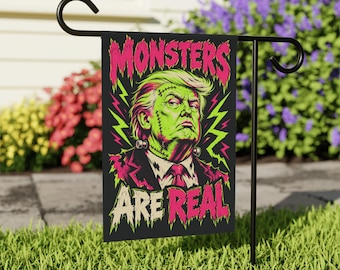 May include: A rectangular garden flag featuring a graphic illustration of a green-skinned figure with stitches on the face and neck, wearing a suit and tie. The text MONSTERS ARE REAL is printed in pink and white with neon green lightning bolts.