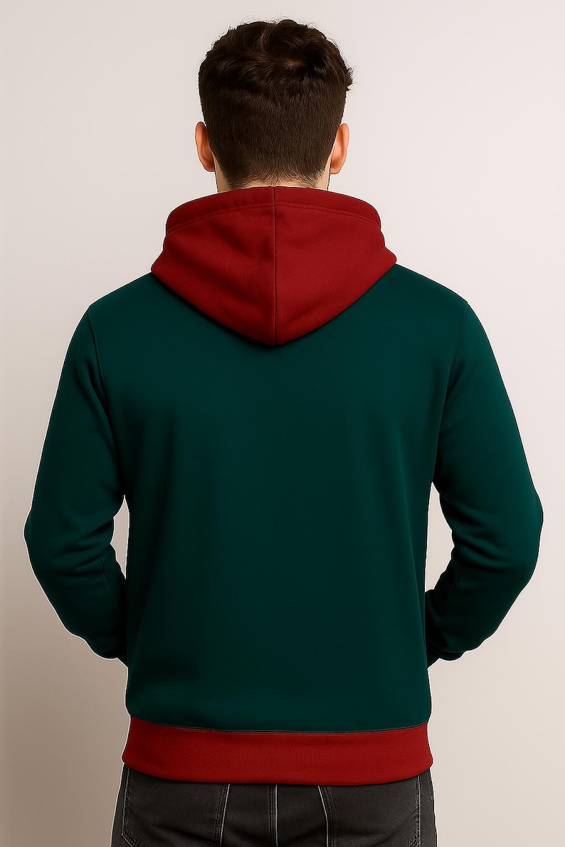May include: A dark green hoodie with a burgundy hood and hem. The back view of the hoodie shows a contrasting color scheme, with the hood and hem in a deep burgundy shade. The hoodie is made of a soft material.