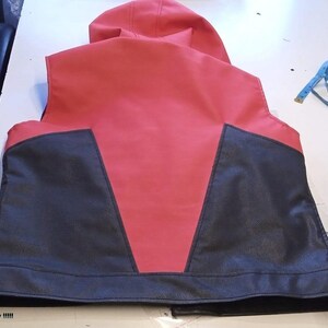 May include: A red and black vest with a hood. The vest has a red body with black panels on the lower front. The text "I am Sorry !!!!!" is visible at the bottom left.