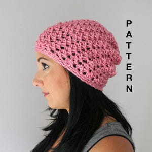 May include: A pink crocheted beanie hat with a slouchy fit. The hat is made with a simple stitch pattern and has a textured look.