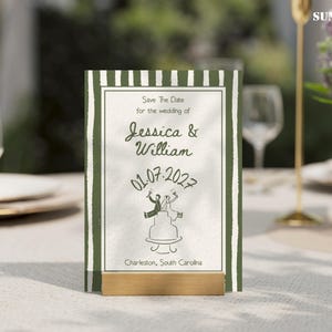 May include: A wedding invitation card with a green and white striped border. The card features the text "Save The Date" and the names "Jessica & William" along with the wedding date, July 1, 2027. The card is displayed on a table.