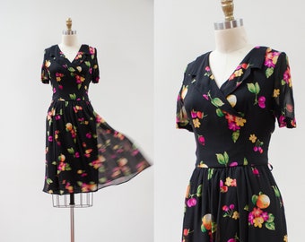 cute cottagecore dress | 90s vintage Dana Buchman black silk chiffon floral fruit pattern surplice fit and flare dress