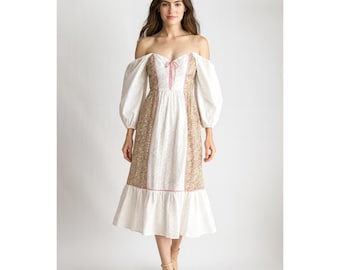May include: Off-the-shoulder dress with white, floral, and pink accents. The dress features a white bodice with a pink bow, floral side panels, and long, puffy sleeves. The skirt has a ruffled hem.