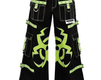 May include: Black cargo pants with neon green accents and a bold graphic design. Features multiple pockets, adjustable straps, and the text "MOOSE NYC". The pants have white stitching and a drawstring waist.
