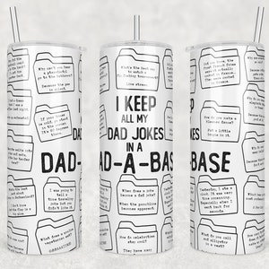 May include: White tumbler with a black and white design featuring a dad joke theme. The tumbler has a black and white pattern of folders with dad jokes written inside. The text "I keep all my dad jokes in a dad-a-base" is printed in black on the tumbler.