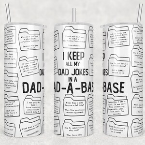 May include: White tumbler with a black and white design featuring a dad joke theme. The tumbler has a black and white pattern of folders with dad jokes written inside. The text "I keep all my dad jokes in a dad-a-base" is printed in black on the tumbler.