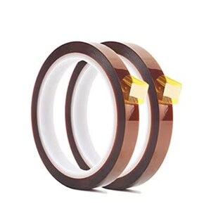 Puede incluir: Dos rollos de cinta marr&oacute;n resistente al calor con respaldo adhesivo dorado. La cinta est&aacute; enrollada sobre s&iacute; misma y los extremos de los rollos son visibles.