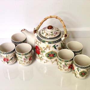 Vintage Asian ceramic tea set with teapot and six matching cups featuring a floral and bird design