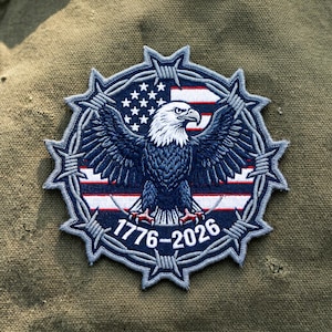 May include: Embroidered patch featuring a bald eagle with outstretched wings, set against a backdrop of the American flag. The design is encircled by a barbed wire border, with the dates "1776-2026" at the bottom. The patch is primarily navy blue, white, and red.