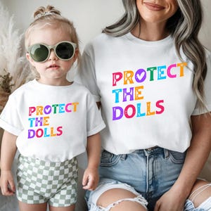 Protect The Dolls Rainbow Graphic Tee: Distressed Retro Pride Top