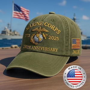 May include: Olive green Marine Corps baseball cap with embroidered gold lettering and emblem. Features the text "MARINE CORPS 1775 2025 250TH ANNIVERSARY" and a small American flag patch. Includes a "MADE IN UNITED STATES" sticker.