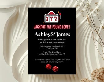May include: Black invitation card with the text "JACKPOT! WE FOUND LOVE!" and the names "Ashley & James". The card includes a slot machine graphic and dice, with the wedding date, time, and venue: The Neon Chapel, Las Vegas, NV.