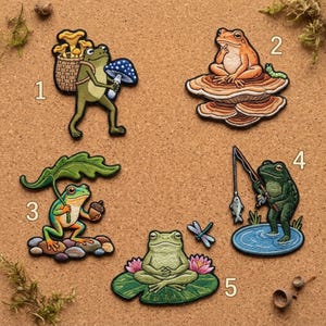May include: Set of five embroidered frog patches. Each patch features a different frog design, including a frog carrying mushrooms, a frog on a mushroom, a frog with an acorn, a frog fishing, and a frog meditating on a lily pad.