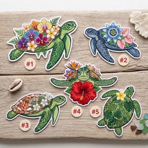 May include: Five colorful turtle patches with floral designs. Each turtle has a different color scheme and flower arrangement, including orchids, hibiscus, and tropical leaves. The patches are numbered #1 through #5.