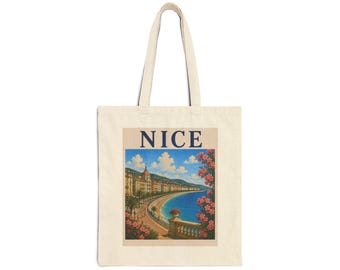 May include: A beige canvas tote bag featuring a rectangular graphic print of the Nice coastline. The illustration depicts a blue sea, a sandy beach, palm trees, buildings, and pink flowers, with the word NICE printed in dark blue capital letters.