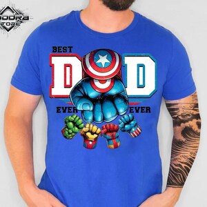 A blue t-shirt with a graphic design featuring a superhero character and the text "BEST DAD EVER" printed on it.