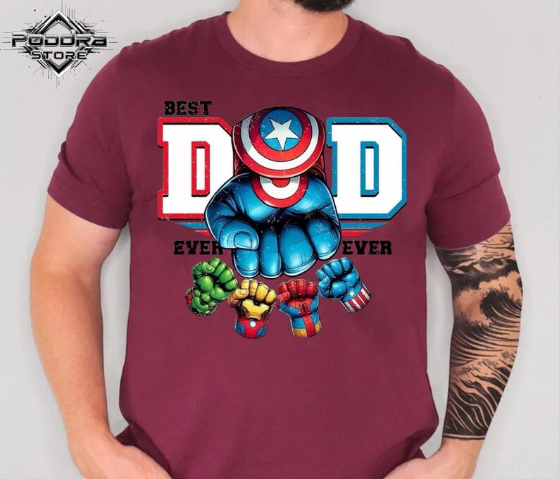 A man wearing a burgundy t-shirt with a graphic design featuring a superhero character and the text "Best Dad Ever".