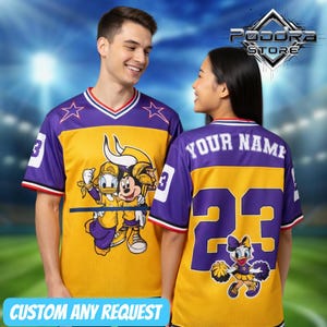 May include: Yellow and purple mesh jersey with cartoon characters Donald Duck and Mickey Mouse. The jersey has a white collar with red trim, star accents, and the number 3. The back features the text "YOUR NAME" and the number 23.