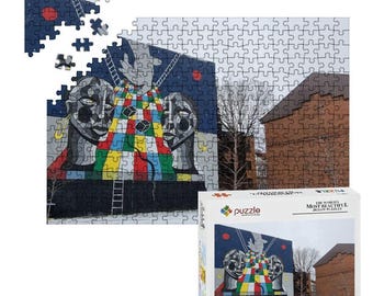 Może przedstawiać: Puzzle przedstawiające kolorowy mural z dwiema twarzami i geometrycznymi kształtami. Puzzle są częściowo ułożone, z kilkoma oddzielnymi elementami. Pudełko przedstawia gotową układankę i tekst "The World's Most Beautiful Jigsaw Puzzles".