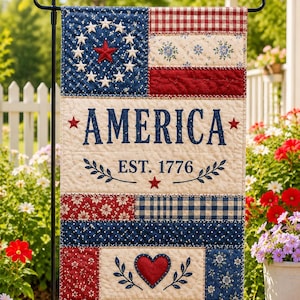 May include: A patriotic garden flag with a quilted design. The flag features the word "AMERICA" and "EST. 1776" in navy blue, along with stars, hearts, and floral patterns in red, white, and blue. The flag is displayed on a black metal stand.