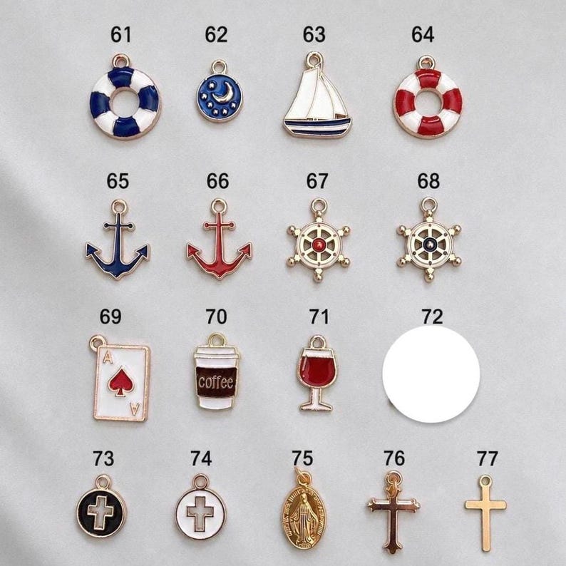 May include: A collection of seventeen metal charms labeled 61 through 77, featuring nautical, beverage, and religious motifs. Designs include life rings, sailboats, anchors, ship wheels, a playing card, a coffee cup, a wine glass, and crosses.