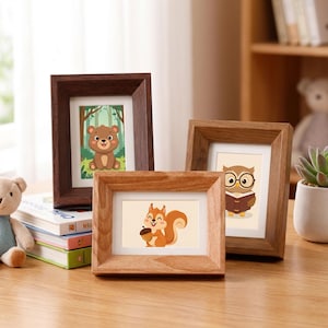 May include: Three wooden picture frames with cartoon animal illustrations. The frames are in shades of brown and feature a bear, an owl, and a squirrel. The frames are on a wooden surface.