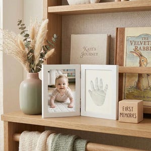 May include: A white ceramic mug with a black handle and the text "But First, Coffee" in a bold, black font. The mug sits on a white surface, showcasing its clean design.