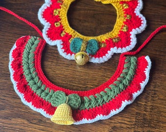 May include: Two handmade crochet pet collars. The top collar is red with a yellow and white scalloped edge, gold accents, and a green bow with a gold bell. The bottom collar is red, green, and white with a yellow bell.