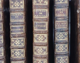 May include: A collection of six antique books with brown leather covers. The spines feature gold lettering and decorative patterns. The titles include "SERMON DE MASSILL" and "CAREME TOM III".