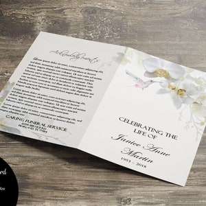 May include: A white funeral programme with a floral design featuring white orchids and a hummingbird. The text reads "Celebrating the Life of Janice Anne Martin 1953-2018".