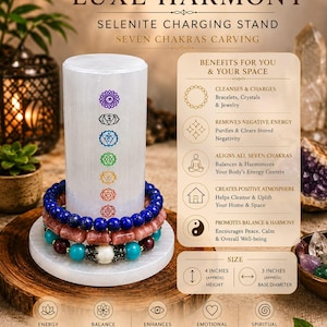 May include: A cylindrical white selenite charging stand featuring a seven chakras carving with coloured symbols. Three beaded bracelets are stacked around the base. Text includes LUXE HARMONY, SELENITE CHARGING STAND, and size specifications of 4 inches height and 3 inches base diameter.