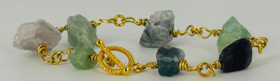 Small green, blue, grey, purple nugget beads bracelet with gold elements