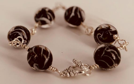 Large black and silver beads linked bracelet