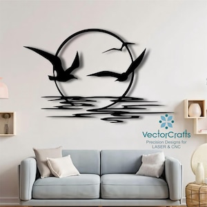 May include: Black metal wall art showing seagulls flying in front of a circular sun, above stylized water lines. The artwork is mounted on a white wall above a grey sofa. The text "VectorCrafts" is visible.