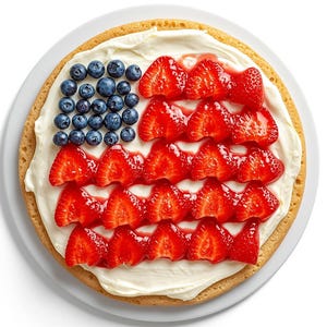 May include: A festive dessert resembling the American flag. The base is a golden-brown pastry, topped with white cream, and decorated with blueberries and sliced strawberries. The dessert is presented on a white plate.