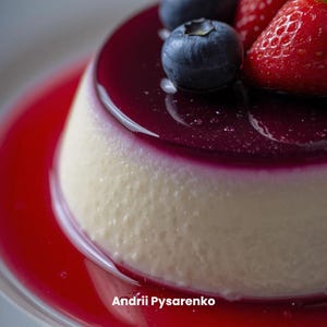 May include: A close-up of a dessert with a white base, topped with a dark purple glaze and fresh blueberries and strawberries. The dessert sits in a red sauce. The text "Andrii Pysarenko" is at the bottom.