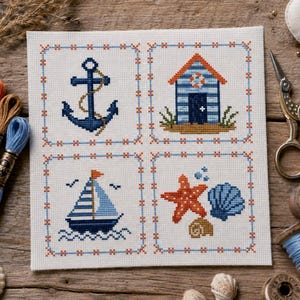 Puede incluir: Una pieza de tela blanca cuadrada con cuatro diseños de punto de cruz dispuestos en cuadrícula. Los diseños incluyen un ancla azul oscuro, una caseta de playa azul y naranja, un velero azul y blanco, y una estrella de mar naranja con dos conchas.