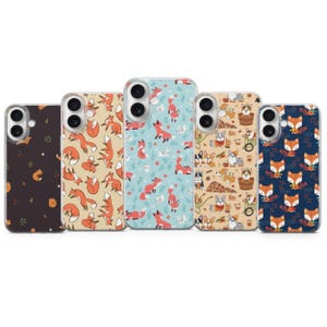 May include: Five phone cases with various patterns. Designs include foxes, corgis, and other woodland creatures. The cases feature a variety of colors, including brown, blue, and tan. The cases are made of a clear material.