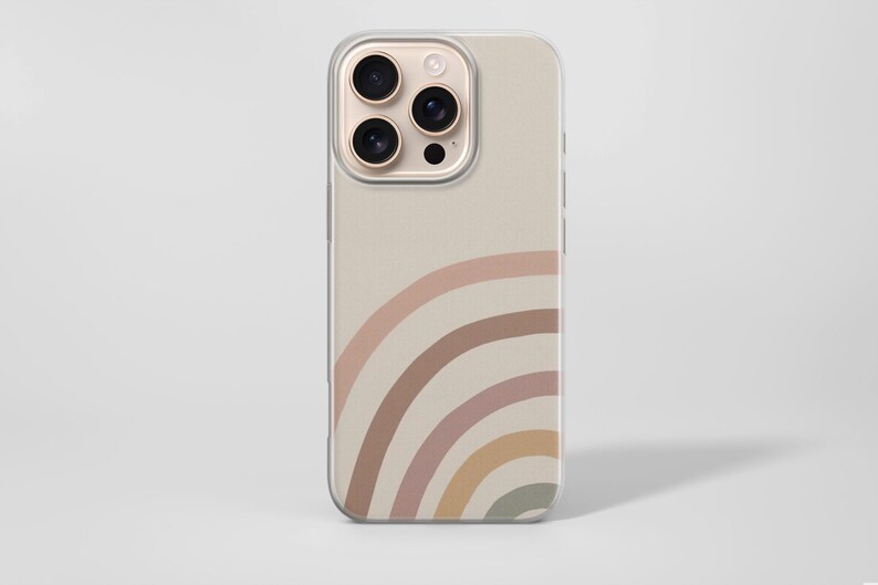 May include: A beige phone case with a rainbow design in muted colors. The rainbow arcs from the bottom left corner, featuring shades of pink, brown, and yellow. The case has a clear border and a camera cutout.