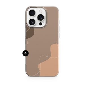 May include: A phone case with a neutral color palette. The case features a design of abstract shapes in shades of brown and tan, with a thin white line. The phone case has a clear border and a camera cutout.