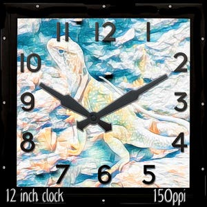 May include: Square wall clock with a black frame. The clock face features a lizard illustration in shades of blue, yellow, and white. Black hands and numerals mark the time. The clock is 12 inches in size.