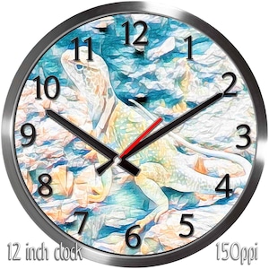 May include: A round wall clock with a silver metal frame. The clock face features a colorful artistic rendering of a lizard against a blue and tan background. Black hands and red second hand indicate the time. The text "12 inch clock" is at the bottom.