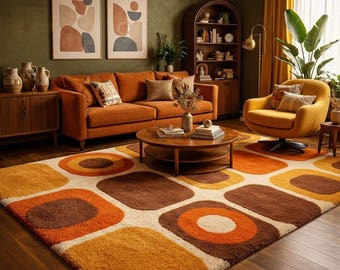May include: A rectangular area rug featuring a repeating geometric pattern of rounded squares and circles in shades of burnt orange, mustard yellow, brown, and cream. The rug has a thick, textured pile and covers a dark wood floor in a living room.