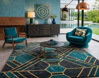 May include: A modern living room featuring a teal rug with geometric patterns in teal, gold, and gray. The room includes a teal armchair, a dark wood cabinet, and a round coffee table. A large window overlooks a pool.
