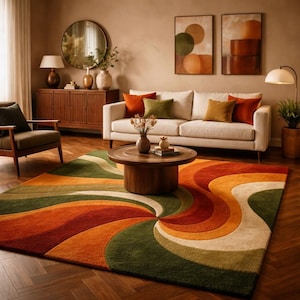 May include: A living room scene featuring a cream-colored sofa with orange and green throw pillows. A large, colorful rug with a swirling pattern in shades of green, orange, and cream dominates the foreground. The room includes a wooden coffee table, a side chair, and artwork.