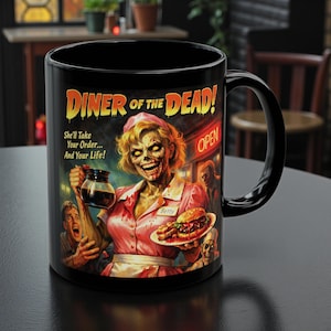 May include: Black ceramic mug featuring a zombie diner waitress holding a coffee pot and a plate of food. The mug has the text "DINER OF THE DEAD!" and "She'll Take Your Order... And Your Life!" in a vintage horror movie style.