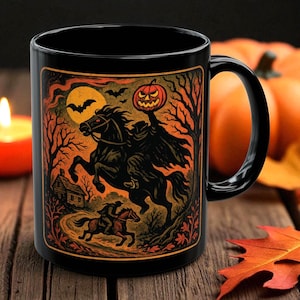A striking mug featuring a haunting vintage-style illustration of the Headless Horseman riding beneath a full moon, pumpkin head glowing in eerie orange. The artwork captures twisted trees, bats, and gothic shadows in bold, fiery tones, wrapping around the mug for a dramatic Halloween aesthetic. Perfect for coffee, tea, or hot cider, this mug is both functional and a piece of gothic folklore art. Original design by The Haunted Hollow Co.™.
