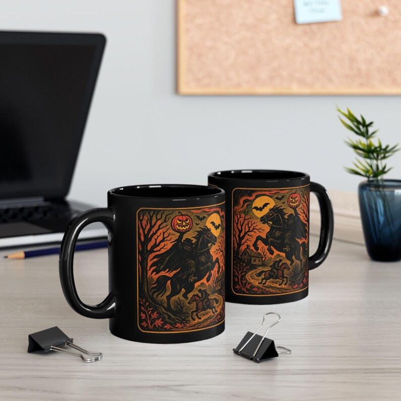 A striking mug featuring a haunting vintage-style illustration of the Headless Horseman riding beneath a full moon, pumpkin head glowing in eerie orange. The artwork captures twisted trees, bats, and gothic shadows in bold, fiery tones, wrapping around the mug for a dramatic Halloween aesthetic. Perfect for coffee, tea, or hot cider, this mug is both functional and a piece of gothic folklore art. Original design by The Haunted Hollow Co.™.
