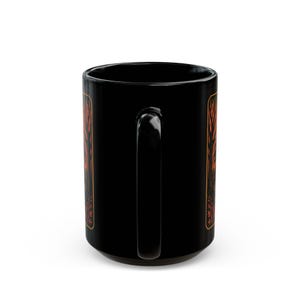 A striking mug featuring a haunting vintage-style illustration of the Headless Horseman riding beneath a full moon, pumpkin head glowing in eerie orange. The artwork captures twisted trees, bats, and gothic shadows in bold, fiery tones, wrapping around the mug for a dramatic Halloween aesthetic. Perfect for coffee, tea, or hot cider, this mug is both functional and a piece of gothic folklore art. Original design by The Haunted Hollow Co.™.