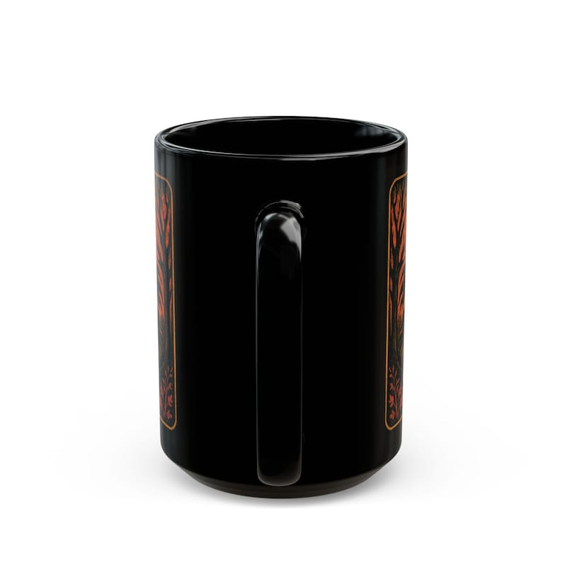 A striking mug featuring a haunting vintage-style illustration of the Headless Horseman riding beneath a full moon, pumpkin head glowing in eerie orange. The artwork captures twisted trees, bats, and gothic shadows in bold, fiery tones, wrapping around the mug for a dramatic Halloween aesthetic. Perfect for coffee, tea, or hot cider, this mug is both functional and a piece of gothic folklore art. Original design by The Haunted Hollow Co.™.
